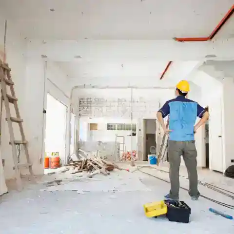 Structural engineer reviewing home addition drawings on site