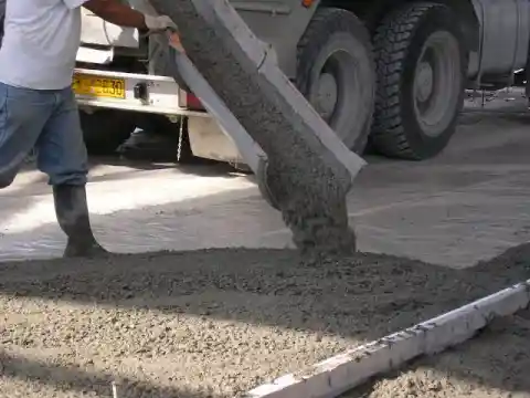 Ready-mix truck discharging concrete on site, illustrating performance-based vs prescriptive concrete specifications for mix design